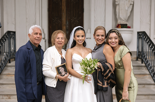 The bride stands with her family outside of a church in Galveston. 