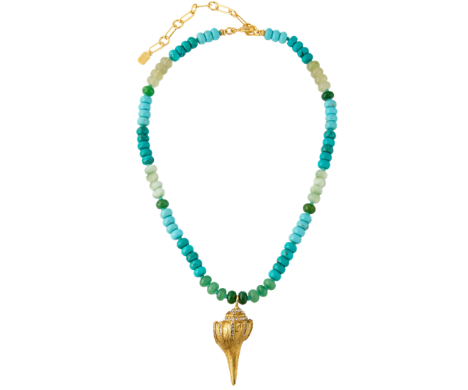 A blue beaded necklace with a conch shell pendant. 