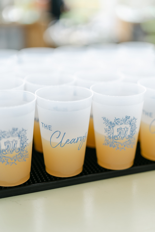 Wedding cups that read "The Cleary's" with an orange mixer inside. 