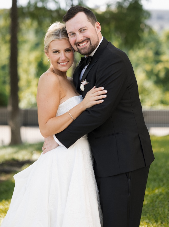The bride and groom smile at the camera for their Houston wedding. 