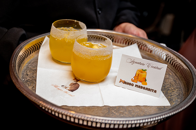 Mango margaritas are served on silver tray at the couple's wedding reception.