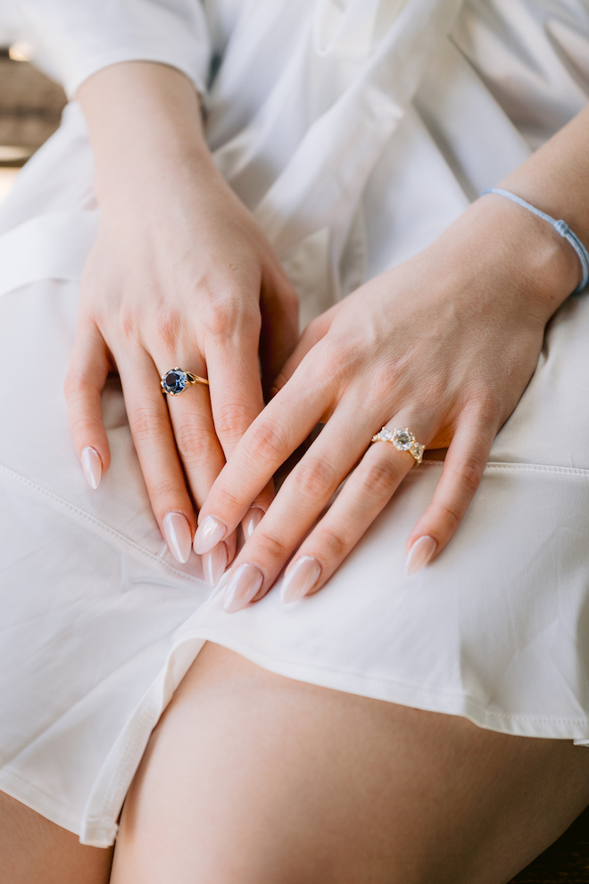 Close up of bride's hands showing engagement ring.