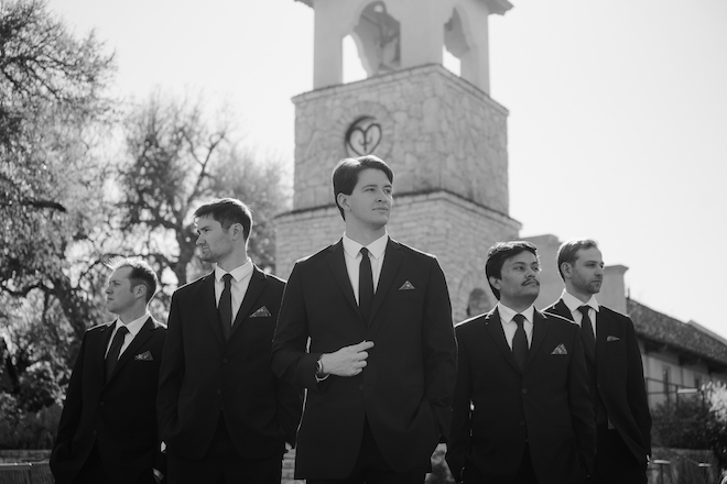 Black and white photo of groom and groomsmen before intimate Hill Country wedding.