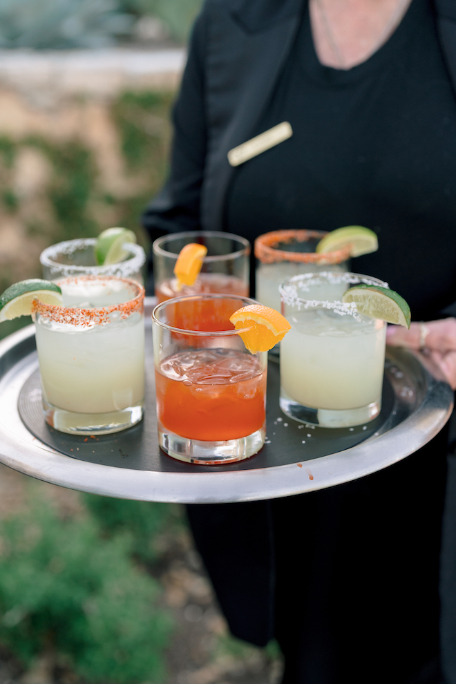 Cocktails being served on a tray during intimate hill country wedding cocktail hour.