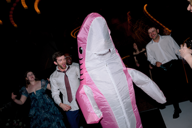 Pink inflatable shark on the dance floor.