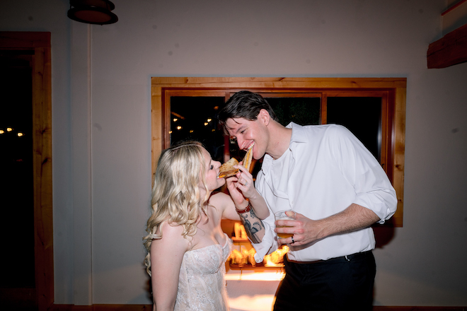 Bride and groom eating a grilled cheese together to end their intimate Hill Country wedding.