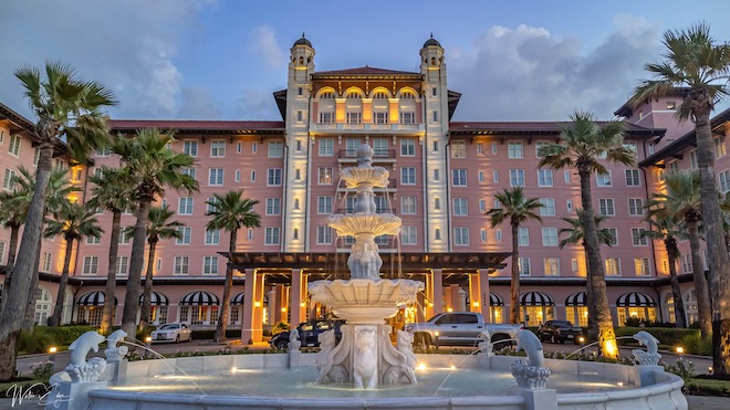 Outside shot of the Grand Galvez in low lighting and showcasing fountain.