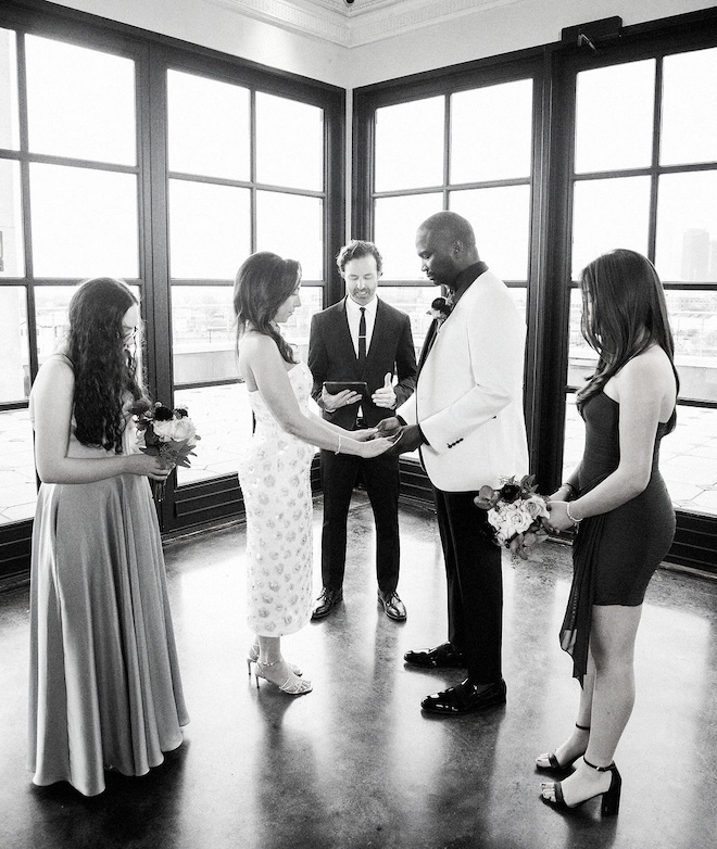 The bride and groom hold hands at their private ceremony at Le Tesserae in Houston. 