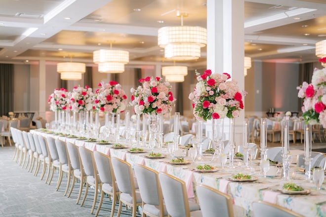 Pink floral arrangements decorate the reception tables in The Tremont House's ballroom. 