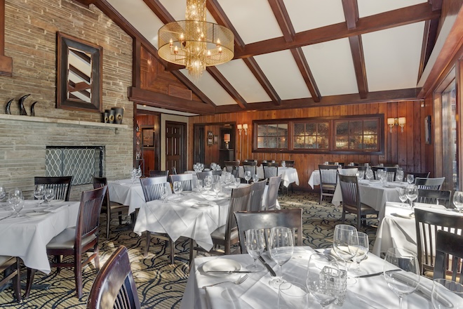 The dining room of Brenner's Steakhouse has exposed wood and brick. 