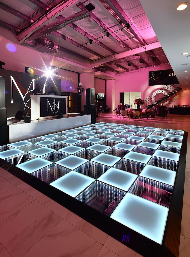 A light up checkered dance floor is at the couples grand Houston wedding. 