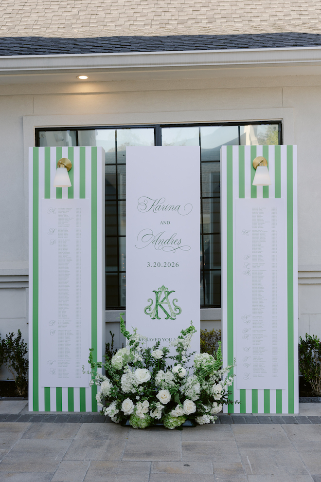 Three pillar green and white welcome sign that reads the guest list and "Karina and Andres". 