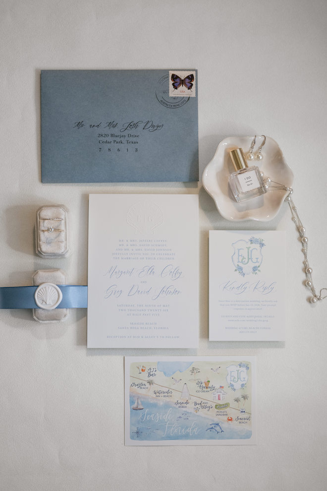 Light blue accented invitations fitting the coastal vibe of the intimate Seaside wedding.