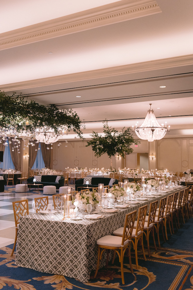 Houstonian venue adorned in green and white greenery and florals with romantic low lighting.