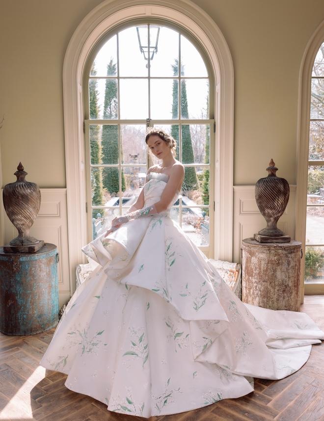 The model wears a lily of the valley wedding dress from Sareh Nouri's spring 2026 collection. 