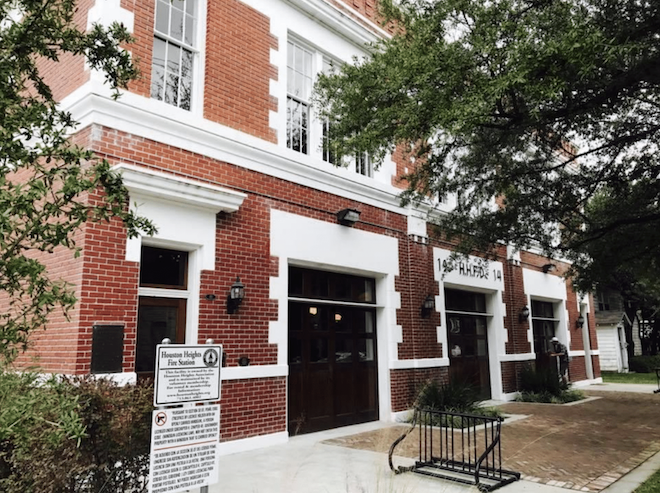Outside view of historic fire station with red and white brick for unique Houston wedding venues.