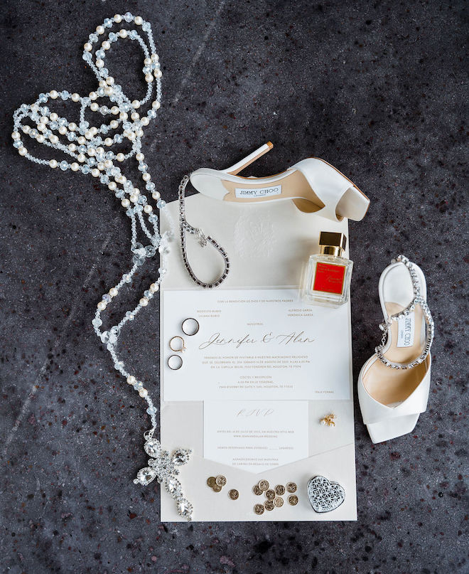 Elegant invitations with jewelry, shoes, and perfume details.