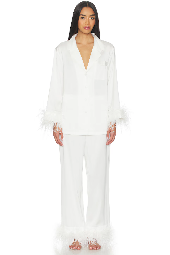 Long sleeved and pants white pajama set with feather details on the cuffs.
