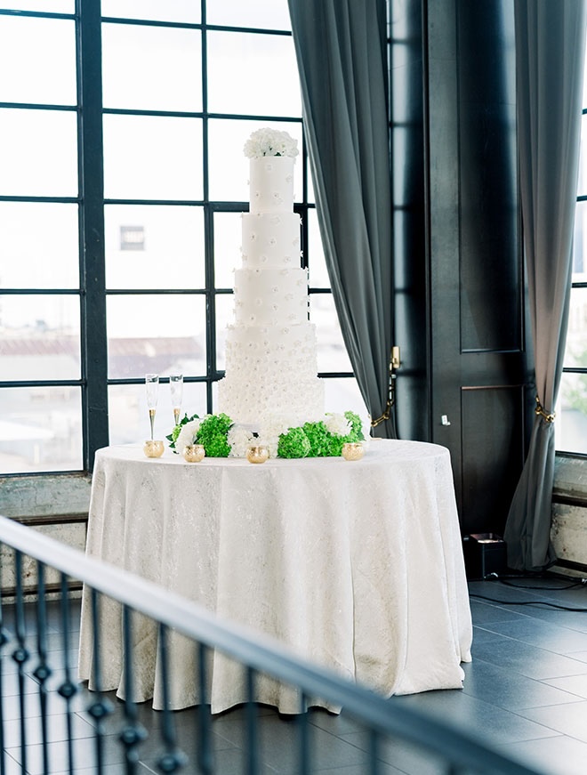 A five-tier wedding cake is the focal point of the wedding reception.