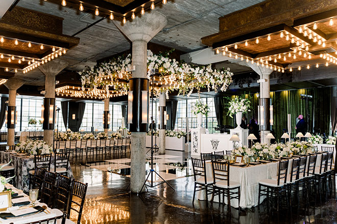 White flowers and greenery decorate the reception table.