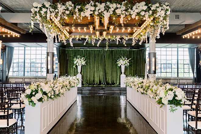 White blooms and greenery detail the wedding ceremony at The Astorian.
