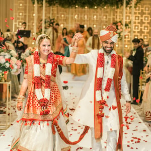 Bride and groom walk down the aisle after their traditional hindu ceremony in Houston.