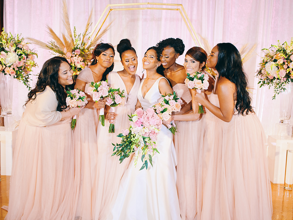 bridal party with gorgeous blush bouquets in front of unique gold octagon altar piece decor 
