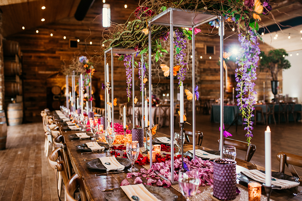 pink purple wedding reception with gorgeous centerpieces on a long table