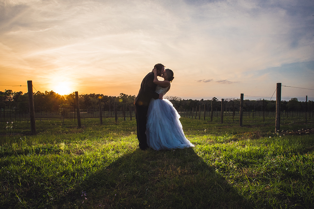 sunset wedding photo, couple kissing