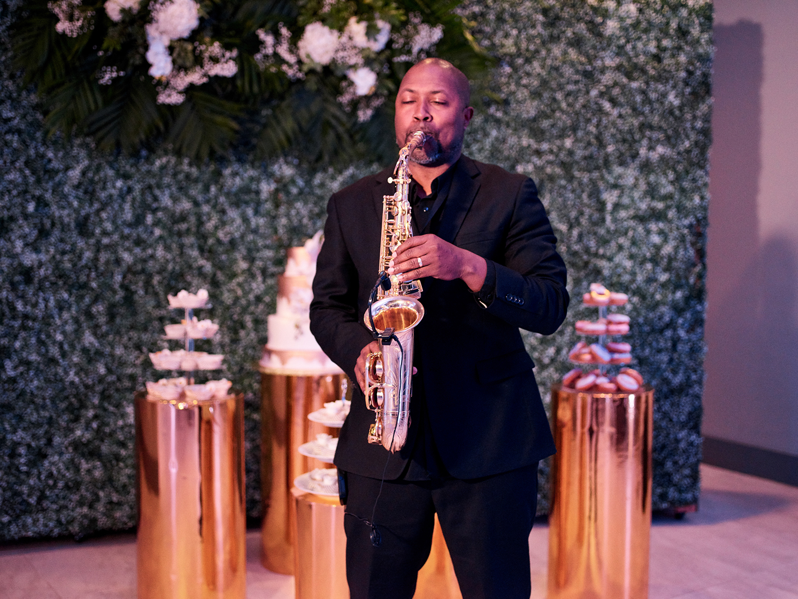 gold cake stands, ivy wall, saxophone at wedding