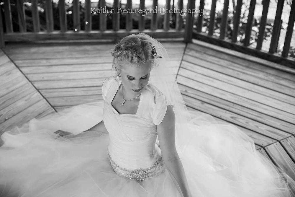 Black and white wedding photography of bride sitting down. 